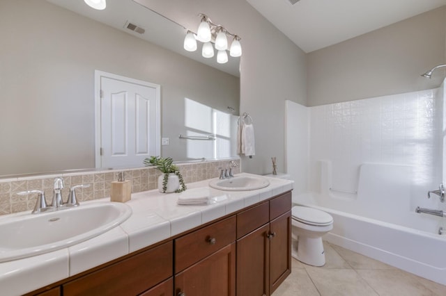 bathroom featuring bathing tub / shower combination, toilet, double vanity, and tile patterned floors