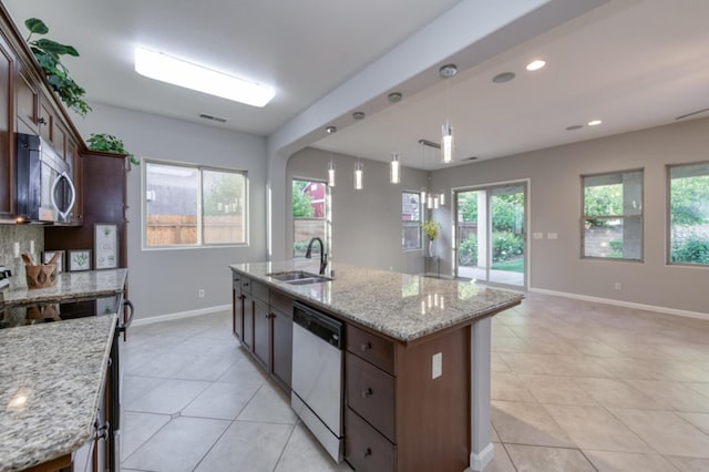 kitchen with dishwashing machine, stainless steel microwave, a sink, range, and light tile patterned floors