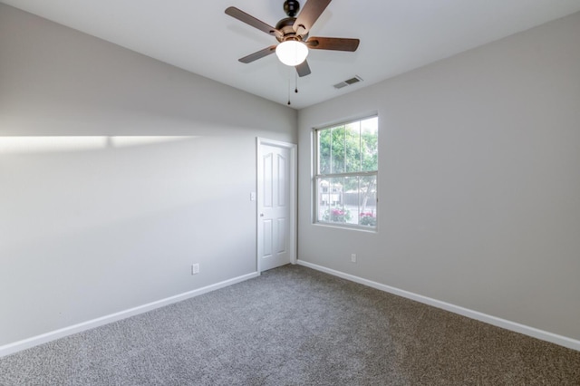 carpeted spare room with baseboards and ceiling fan