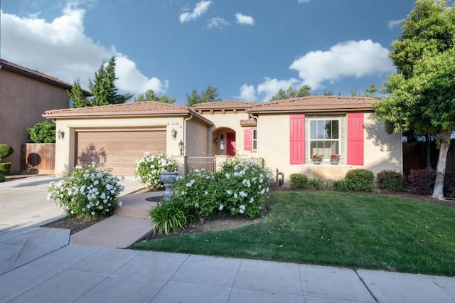 mediterranean / spanish-style house with stucco siding, a garage, concrete driveway, and a front lawn