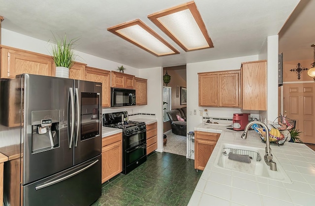 3042 Love St, Selma, CA 93662 - kitchen with black appliances, tile counters, a sink, and a peninsula