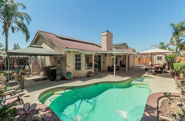 3042 Love St, Selma, CA 93662 - rear view of property with a gazebo, stucco siding, a fenced backyard, a chimney, and a patio