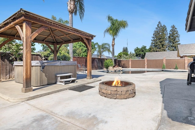 2371 Sophia Ln, Kingsburg, CA 93631 - view of patio / terrace with a hot tub, a gazebo, a fire pit, and a fenced backyard