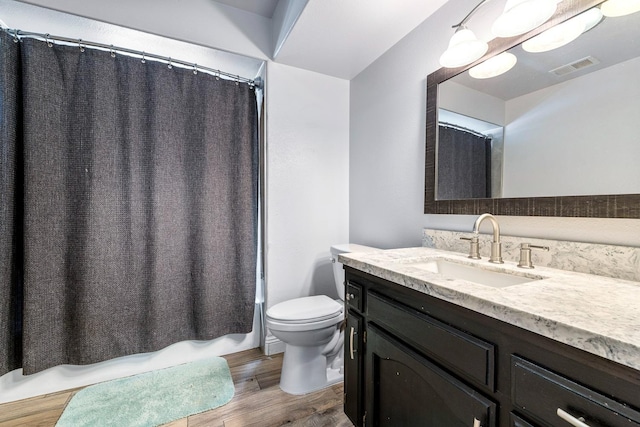 2371 Sophia Ln, Kingsburg, CA 93631 - bathroom featuring wood finished floors, toilet, and vanity