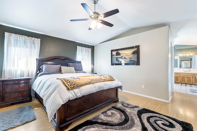 2371 Sophia Ln, Kingsburg, CA 93631 - bedroom featuring vaulted ceiling, light wood-style flooring, ensuite bath, baseboards, and a ceiling fan