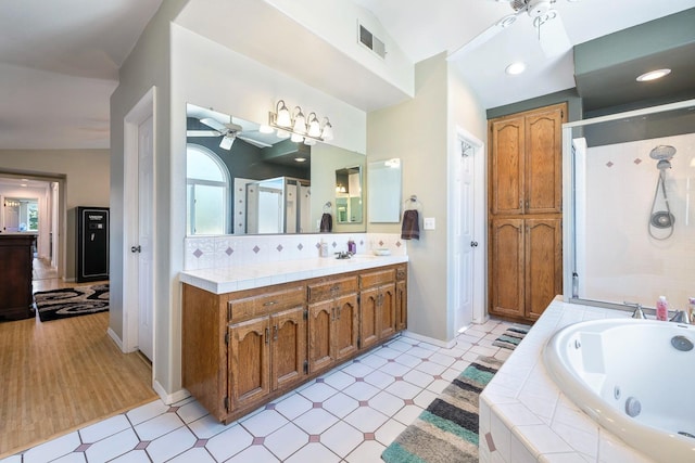 2371 Sophia Ln, Kingsburg, CA 93631 - full bathroom featuring a ceiling fan, a jetted tub, baseboards, a shower stall, and vanity