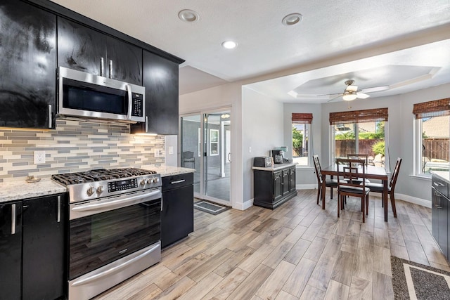 2371 Sophia Ln, Kingsburg, CA 93631 - kitchen featuring dark cabinets, appliances with stainless steel finishes, baseboards, a ceiling fan, and recessed lighting