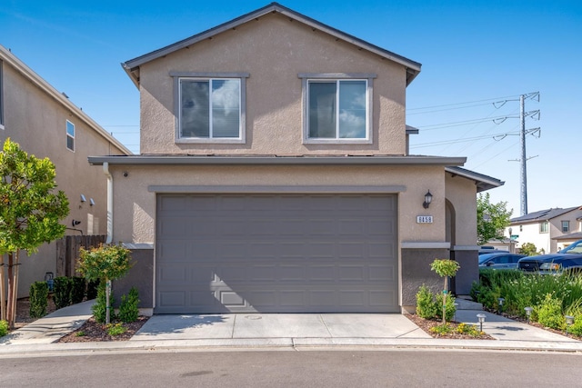 6458 E Riesling Dr, Fresno, CA 93727 - view of front of house with stucco siding, an attached garage, and concrete driveway