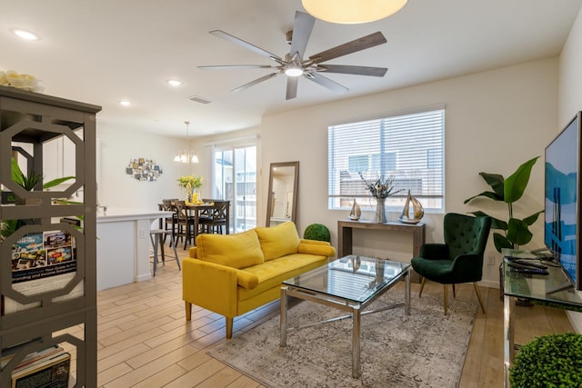 6458 E Riesling Dr, Fresno, CA 93727 - living room with light wood-style floors, recessed lighting, a ceiling fan, and a chandelier