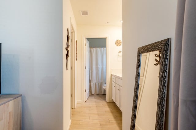 6458 E Riesling Dr, Fresno, CA 93727 - full bathroom with wood finished floors, vanity, and a shower with shower curtain