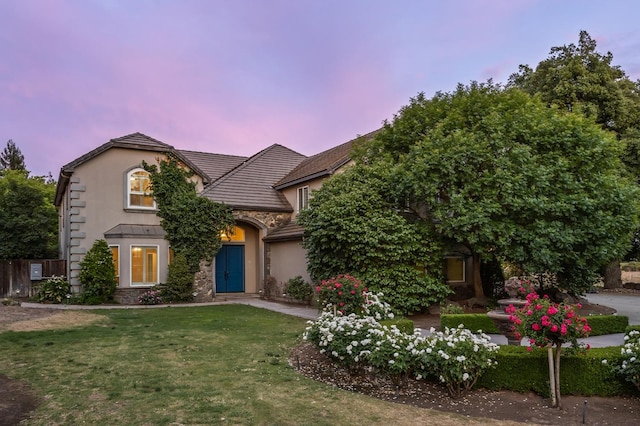 2758 N Highland Ave, Fresno, CA 93737 - view of front of house featuring a front lawn, stucco siding, stone siding, and a tile roof