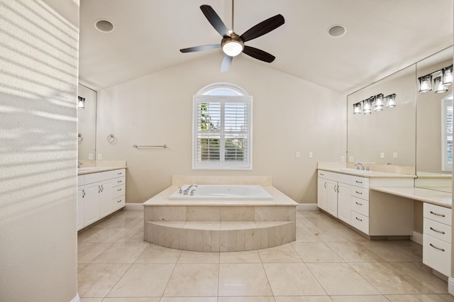 2758 N Highland Ave, Fresno, CA 93737 - bathroom with two vanities, a ceiling fan, a bath, vaulted ceiling, and baseboards