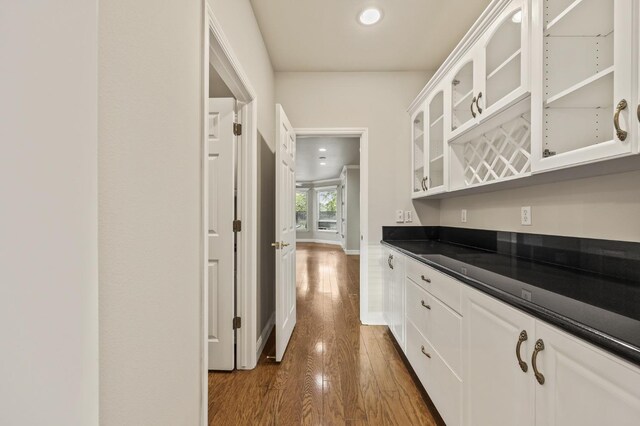 2758 N Highland Ave, Fresno, CA 93737 - kitchen featuring dark countertops, dark wood-style floors, white cabinets, glass insert cabinets, and recessed lighting