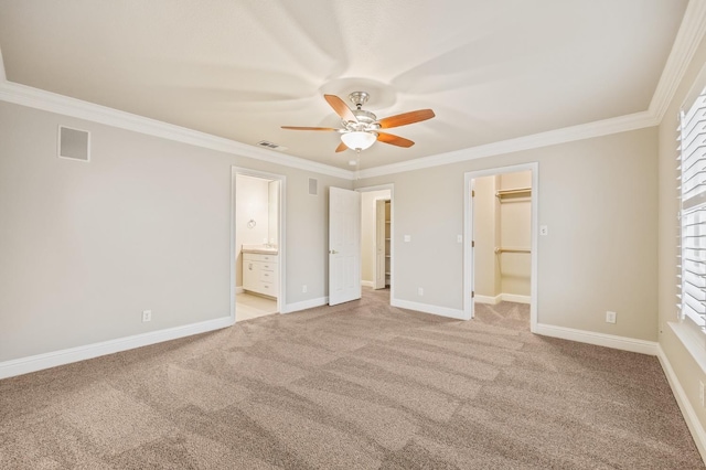 2758 N Highland Ave, Fresno, CA 93737 - unfurnished bedroom featuring a spacious closet, ornamental molding, light carpet, connected bathroom, and baseboards
