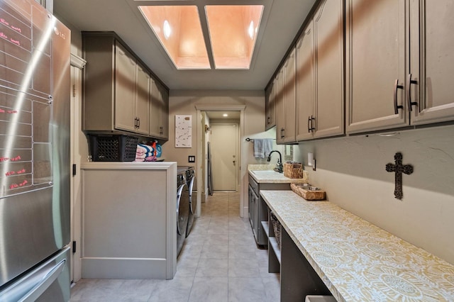 1517 W Fir Ave, Fresno, CA 93711 - washroom featuring independent washer and dryer, a sink, and light tile patterned floors