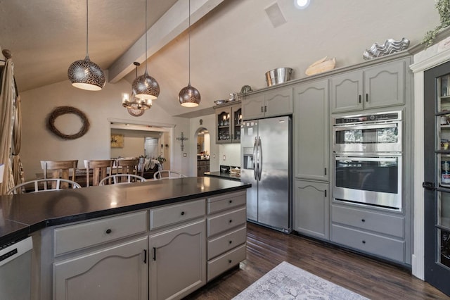 1517 W Fir Ave, Fresno, CA 93711 - kitchen with appliances with stainless steel finishes, dark countertops, dark wood finished floors, and hanging light fixtures