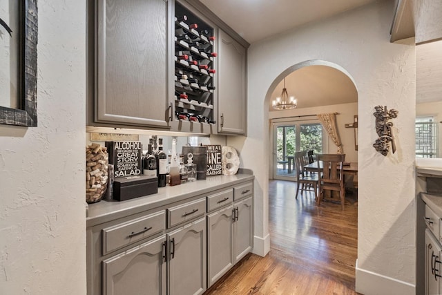 1517 W Fir Ave, Fresno, CA 93711 - bar with arched walkways, light wood-style floors, and a textured wall