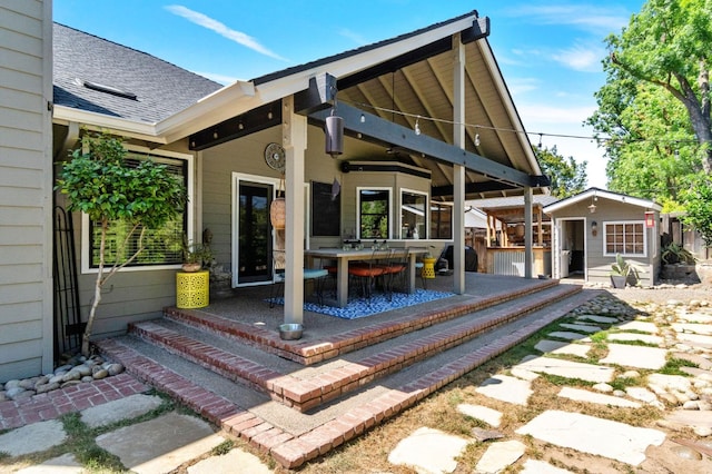 1517 W Fir Ave, Fresno, CA 93711 - back of property with a patio area, an outbuilding, a shingled roof, and outdoor dining area