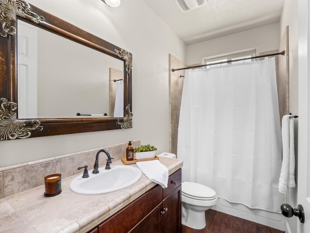bathroom with toilet, vanity, wood finished floors, and shower / bathtub combination with curtain