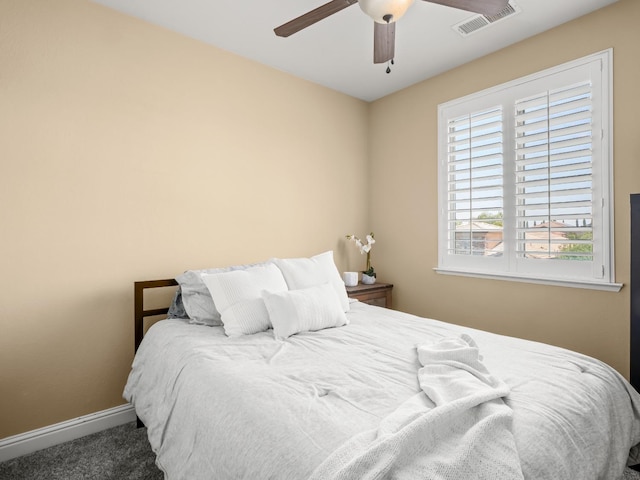 carpeted bedroom featuring baseboards and a ceiling fan