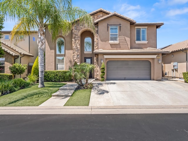 view of front of property with a garage, stucco siding, driveway, a tile roof, and a front yard