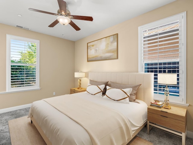 bedroom with carpet, baseboards, and a ceiling fan