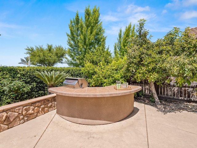 view of patio / terrace with an outdoor kitchen and fence