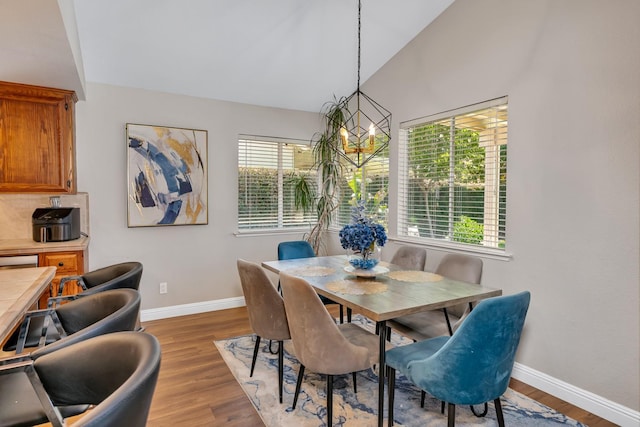 22 Pointe W, Madera, CA 93637 - dining space with baseboards, a chandelier, wood finished floors, and lofted ceiling