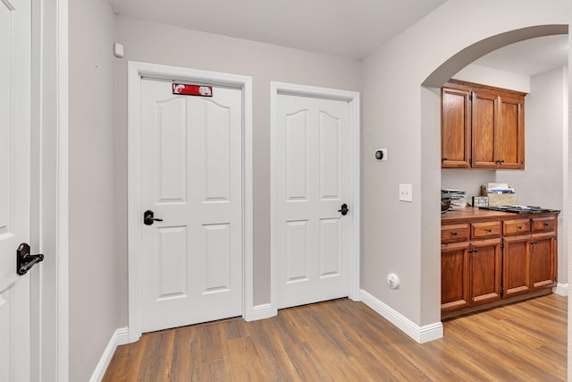 22 Pointe W, Madera, CA 93637 - corridor with light wood finished floors, arched walkways, and baseboards
