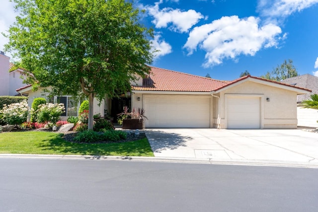 22 Pointe W, Madera, CA 93637 - view of front of property with an attached garage, a tiled roof, stucco siding, and driveway