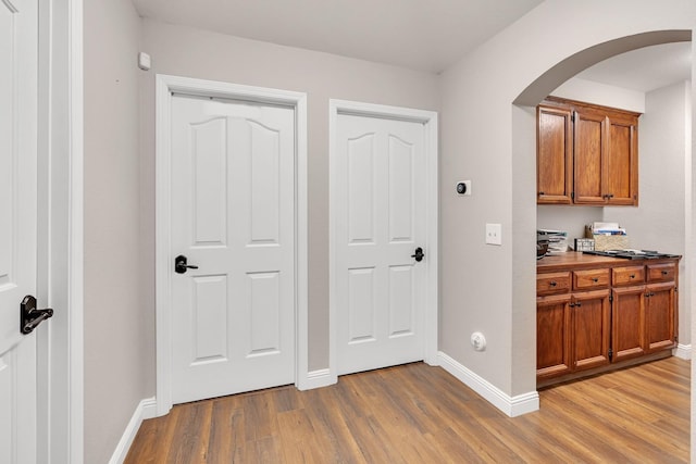 22 Pointe W, Madera, CA 93637 - hall featuring light wood-style floors, arched walkways, and baseboards