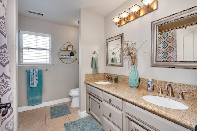 22 Pointe W, Madera, CA 93637 - bathroom with double vanity, toilet, tile patterned flooring, and baseboards