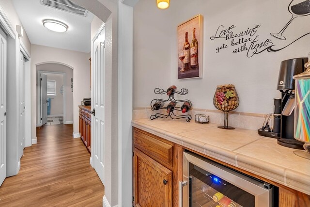 22 Pointe W, Madera, CA 93637 - indoor dry bar with arched walkways, wine cooler, light wood finished floors, and baseboards