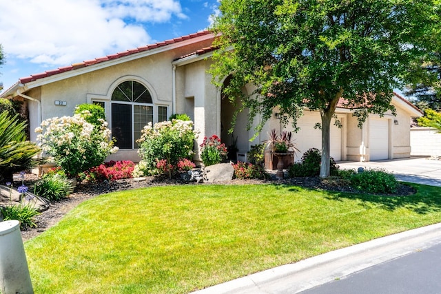 22 Pointe W, Madera, CA 93637 - mediterranean / spanish-style house with driveway, stucco siding, a front lawn, an attached garage, and a tiled roof