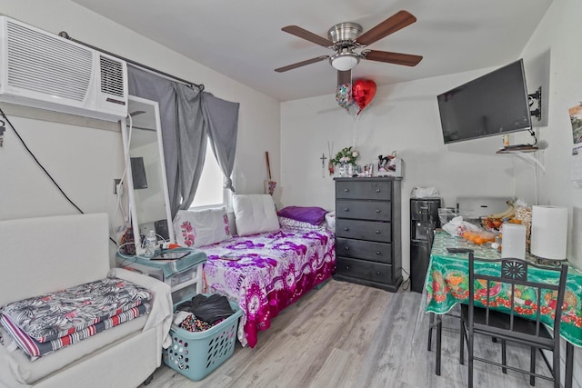 1197 Pucheu St, Mendota, CA 93640 - bedroom with wood finished floors, an AC wall unit, and a ceiling fan