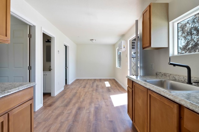 1197 Pucheu St, Mendota, CA 93640 - kitchen featuring a sink, healthy amount of natural light, light wood-style flooring, and light countertops
