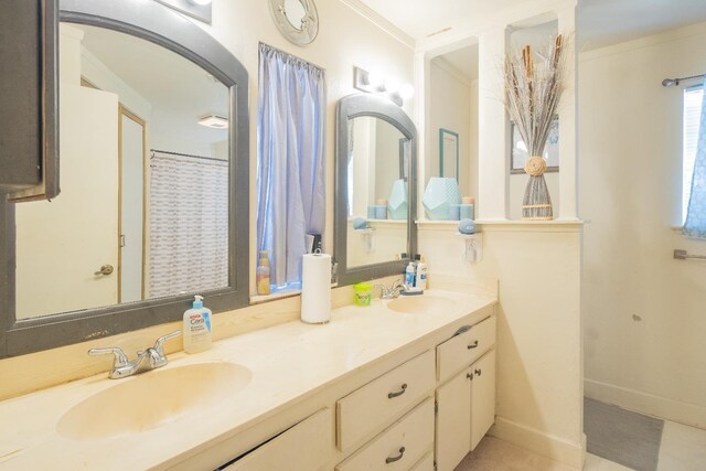 bathroom featuring double vanity and crown molding