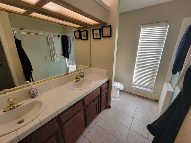 5566 W Fir Ave, Fresno, CA 93722 - bathroom with a shower stall, toilet, double vanity, and tile patterned flooring