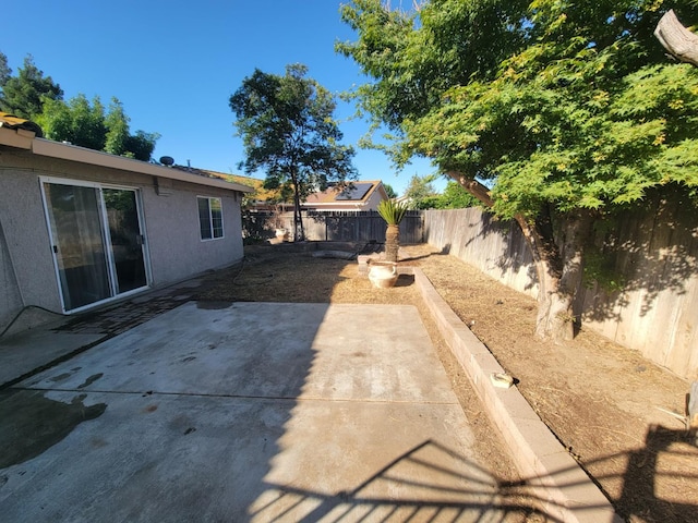 5566 W Fir Ave, Fresno, CA 93722 - fenced backyard featuring a patio