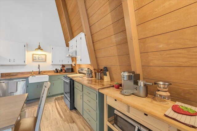 30830 Old Strawberry Rd, Tuolumne, CA 95375 - kitchen with stainless steel appliances, green cabinetry, a sink, under cabinet range hood, and white cabinetry