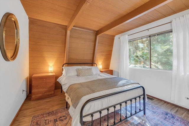 30830 Old Strawberry Rd, Tuolumne, CA 95375 - bedroom featuring wood walls, beamed ceiling, wooden ceiling, wood finished floors, and baseboards