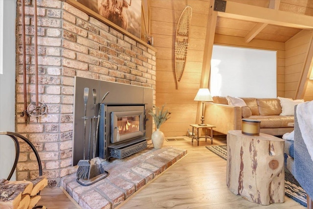 30830 Old Strawberry Rd, Tuolumne, CA 95375 - living room featuring wood finished floors, beamed ceiling, wooden walls, a fireplace, and wooden ceiling