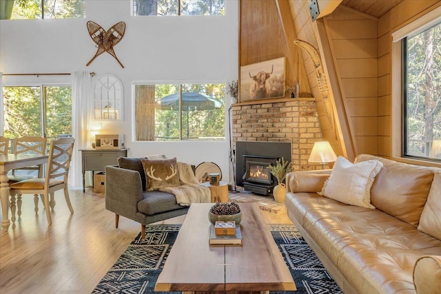 30830 Old Strawberry Rd, Tuolumne, CA 95375 - living area featuring light wood-style floors, high vaulted ceiling, and a brick fireplace