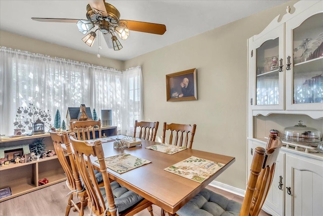dining area featuring ceiling fan, wood finished floors, and baseboards