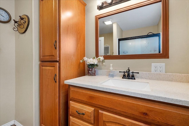 bathroom with vanity and a shower with door
