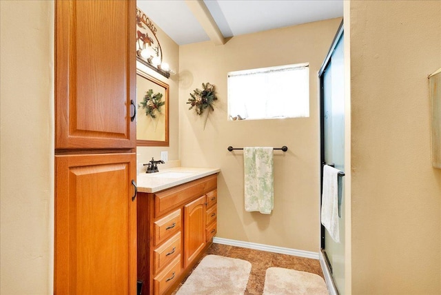 full bath featuring a shower stall, vanity, tile patterned floors, and baseboards