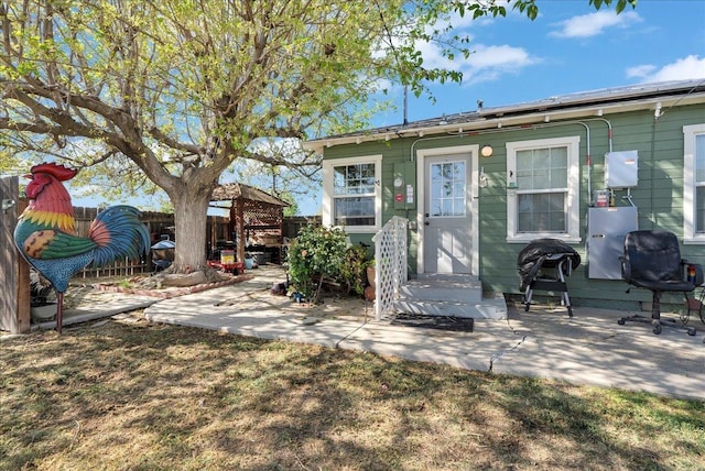 back of property featuring a fenced backyard and a patio area