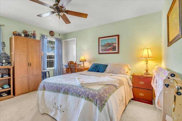 bedroom featuring light carpet and ceiling fan