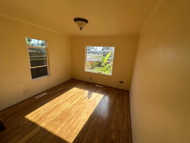 1441 N Calaveras St, Fresno, CA 93728 - unfurnished room with plenty of natural light and dark wood-style floors