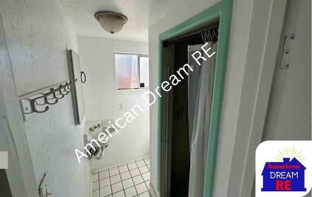 hallway with tile patterned flooring